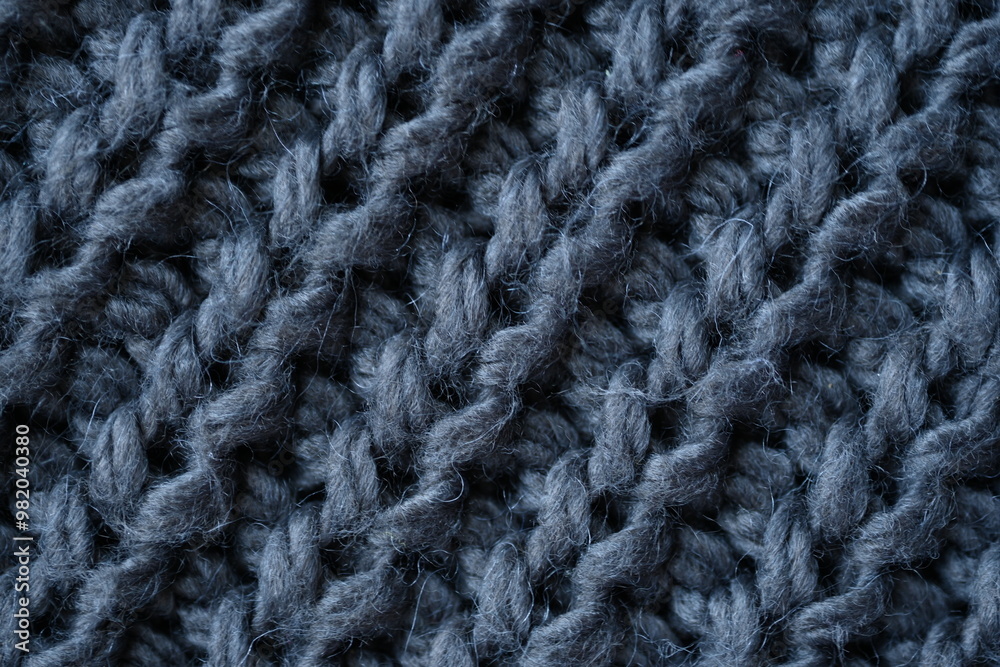 macro texture of woolen dark gray crocheted sweater as background, close-up of gray crocheted front surface, woolen texture of woolen wool, knitted front surface macro texture of woolen dark gray crocheted sweater as background, close-up of gray crocheted front surface, woolen texture of woolen wool, knitted front surface
