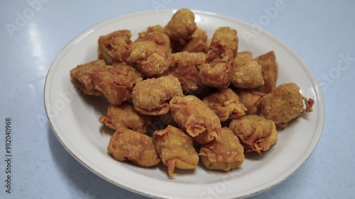 Close-up view of the deep fried pork dumpling on the plate. It also knowns as wontons