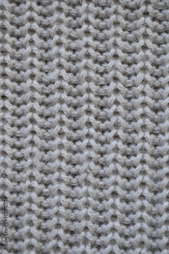 macro texture of woolen pastel crocheted sweater as background, close-up of brown crocheted front surface, woolen texture of woolen wool, trend pastel crocheted front surface photo