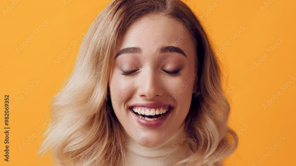 A joyful young woman with wavy hair smiles broadly, showcasing her happiness in front of a vibrant yellow backdrop, capturing a moment of pure delight and positivity. A joyful young woman with wavy hair smiles broadly, showcasing her happiness in front of a vibrant yellow backdrop, capturing a moment of pure delight and positivity.