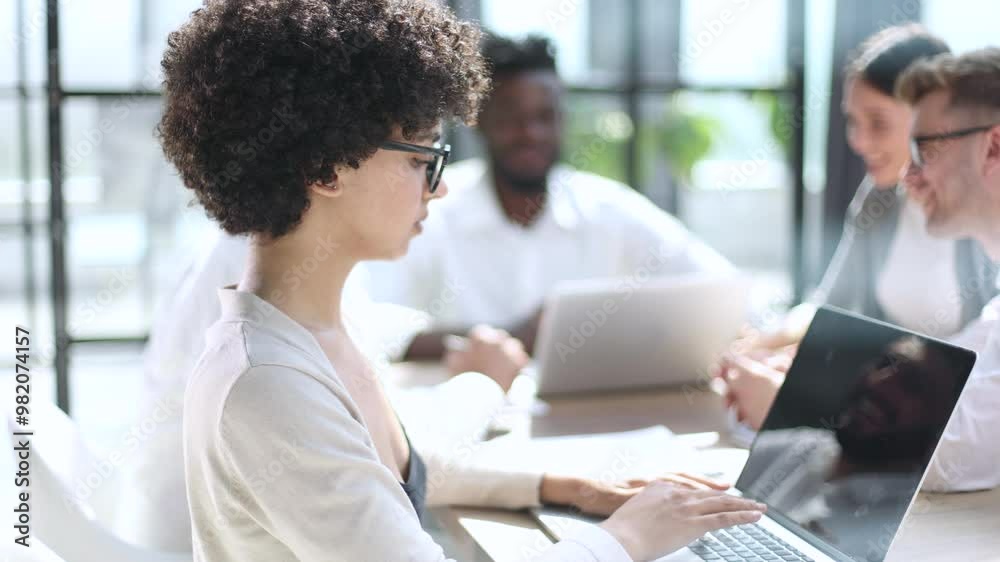 smiling African American business man with executives working in background smiling African American business man with executives working in background