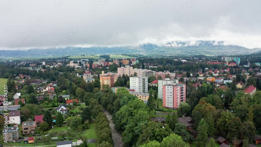 Drone shot of strong current river in the city under mountains Drone shot of strong current river in the city under mountains