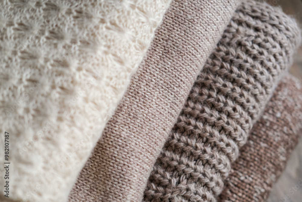 Close-up of a stack of knitted items in beige and brown tones Close-up of a stack of knitted items in beige and brown tones