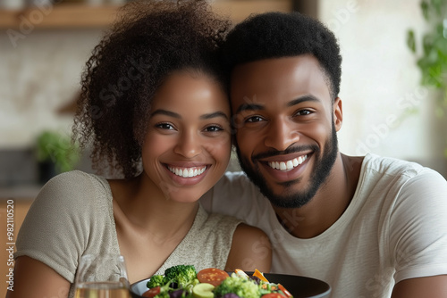 A smiling couple enjoying a nutritious meal in a modern kitchen