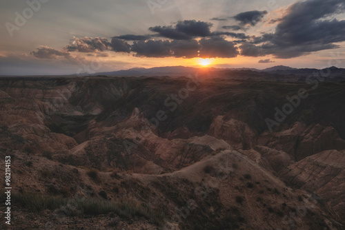 Yellow Canyon is also called the lunar canyon in Kazakhstan near the Charyn River at sunset with the rays of the sun on the heights of clay castles. photo