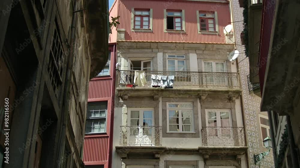 Static shot of a building with some laundry hanging on the balcony in Porto.