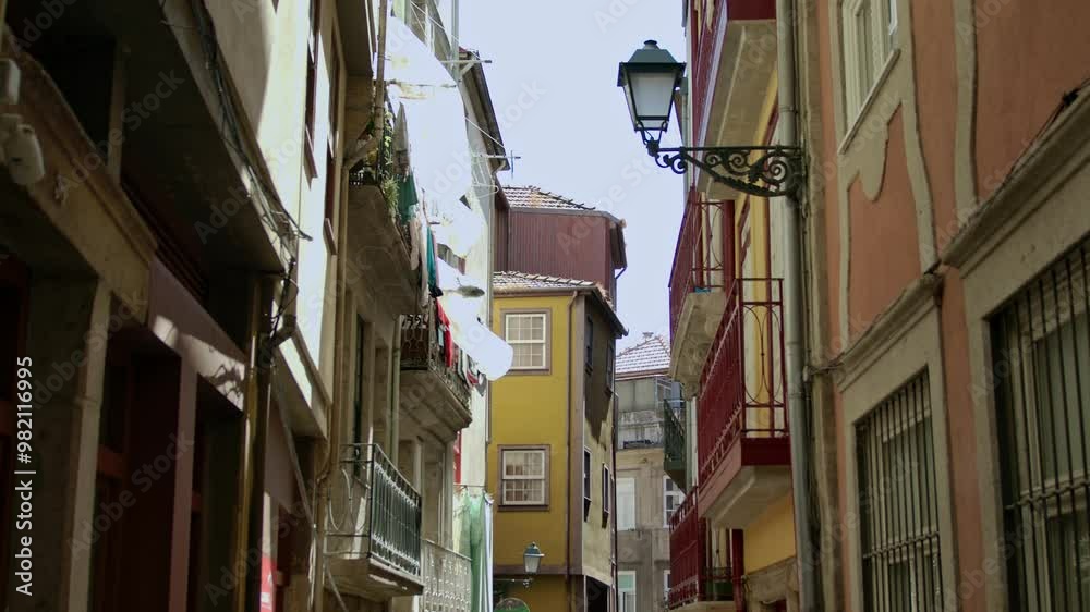 A handheld, stabilized shot of the buildings by the streets in Porto, Portugal.