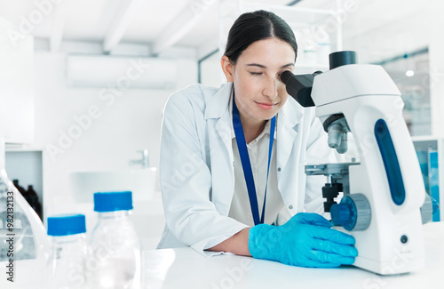 Microscope, woman and scientist checking for science breakthrough, clinical trial and discovery. Biotechnology, medical equipment and vaccine research in lab with petri dish for mpox cure development