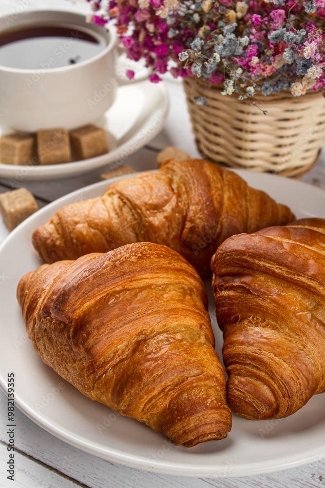 Tea with croissants on a light table. Sweet breakfast