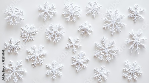 A collection of intricately designed white snowflakes on a light background, perfect for winter-themed projects and decorations.