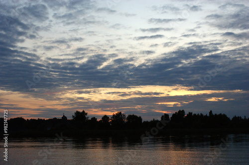 Niegocin lake Mazury Poland sunset on the lake with orange sky cloudy clouds red and purple sun photo