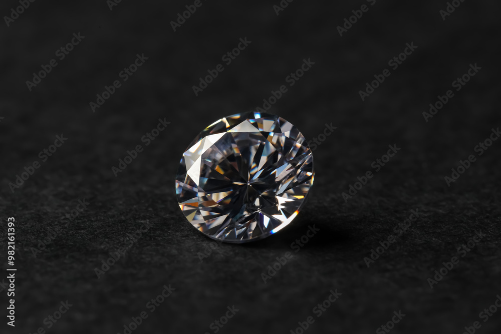 Beautiful shiny diamond on black table, closeup Beautiful shiny diamond on black table, closeup