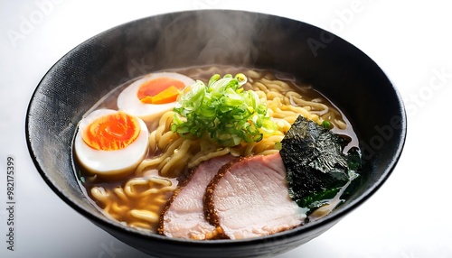 Delicious steaming bowl of ramen noodles with pork, egg and seaweed