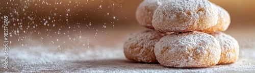 Delicious powdered sugar dusted cookies stacked on a wooden surface, perfect for any sweet treat lovers.