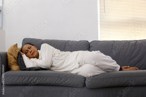 Peaceful Mature Asian Woman Relaxing, Sleeping Or Taking Nap On Comfortable Sofa At Home