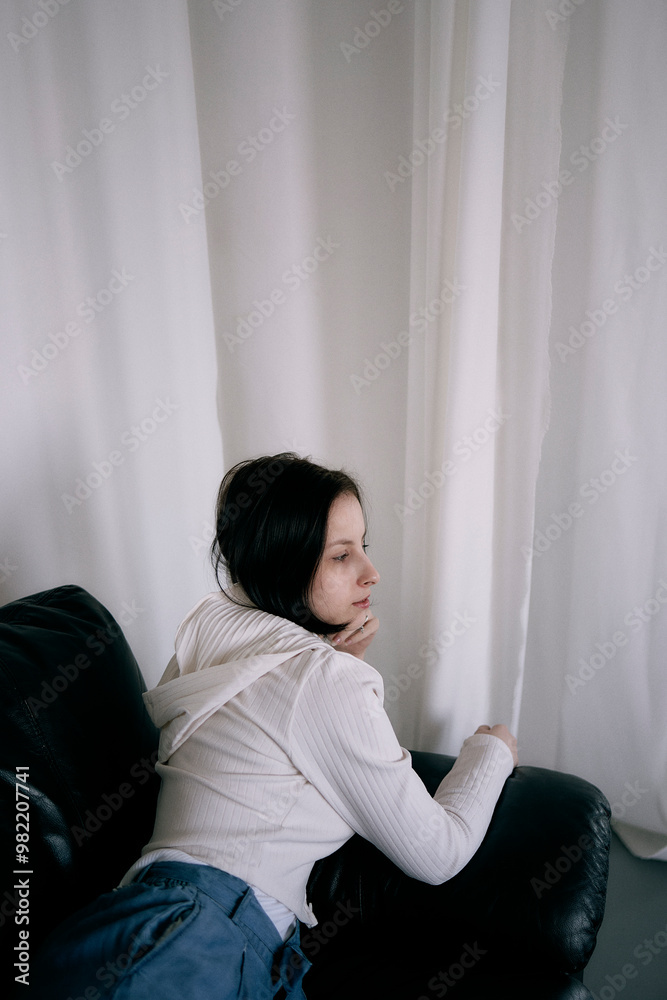 young teenage girl fighting brain cancer at photo shoot in studio, metal wall, reflection, black sofa young teenage girl fighting brain cancer at photo shoot in studio, metal wall, reflection, black sofa