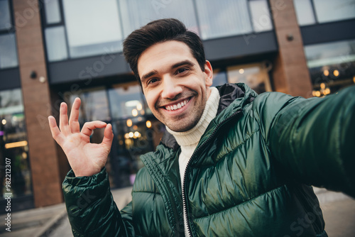 Photo of young positive attractive man dressed trendy clothes recording video blog live streaming okey sign