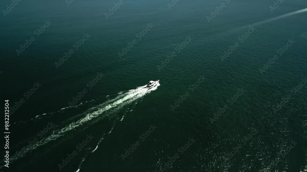 Slow drone tilt up following a yacht sailing across the open ocean as the drone reveals the horizon scattered with other boats and small islands in the distance surrounded by tropical water in the sun Slow drone tilt up following a yacht sailing across the open ocean as the drone reveals the horizon scattered with other boats and small islands in the distance surrounded by tropical water in the sun