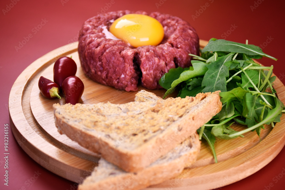Tartar with egg and arugula. fresh ground meat with seasonings. fresh greens. Tartar with egg and arugula. fresh ground meat with seasonings. fresh greens.