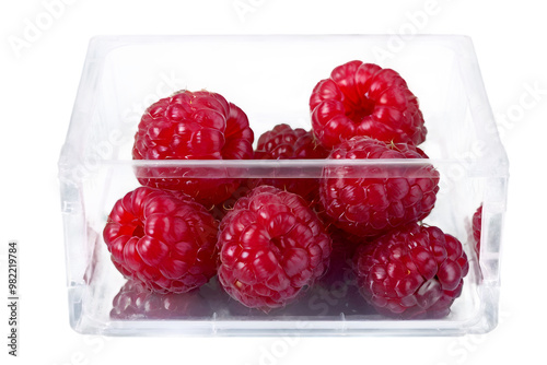 Obraz na płótnie Closeup of organic Raspberries in plastic packaging box, super foods, healthy fruit isolated on transparent background w salonie
