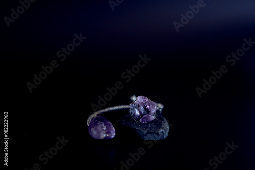amethyst ring and pendant necklace on black background, jewelry