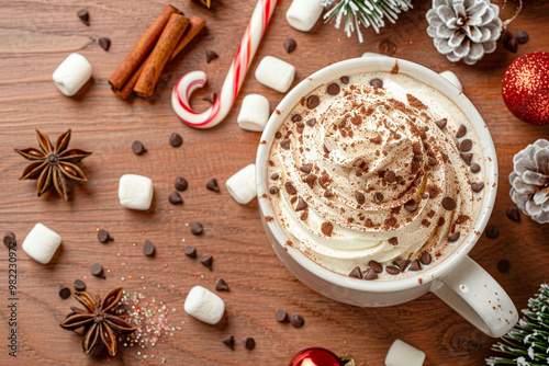 Cup with cocoa and marshmallow on the wooden table. New year and Christmas holidays, winter flat lay background.