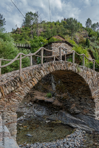 Stone bridge arch over a stream in the schist village of Foz d'Égua at the foot of the mountain, Arganil PORTUGAL