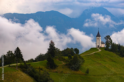 Jamnik, Slovenia - Magical foggy summer day at Jamnik St.Primoz church. photo