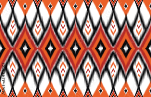 Vibrant pattern ikat ethnic seamless background. Geometric aztec design. Trendy bohemian style. Abstract diamond in orange, black, white colors. Modern textile pattern for fashion and home decor.