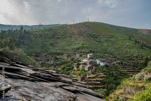 Schist houses in Foz d'Égua on the mountain seen from the schist roof in blur, Arganil PORTUGAL photo