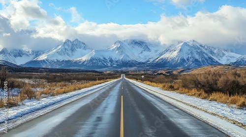 A Snowy Road Leading to a Mountain Range