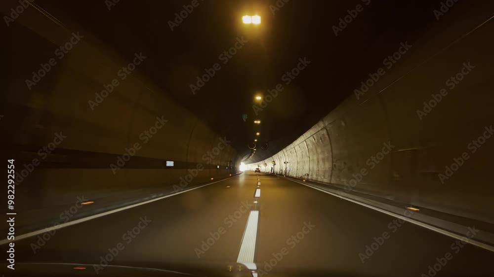 POV of Car Driving Toward Light at the End of the Tunnel. Concept of hope, freedom, escape, clarity, new beginning, optimistic, enlightenment, near death, rebirth, mysterious, transcendence, exit POV of Car Driving Toward Light at the End of the Tunnel. Concept of hope, freedom, escape, clarity, new beginning, optimistic, enlightenment, near death, rebirth, mysterious, transcendence, exit
