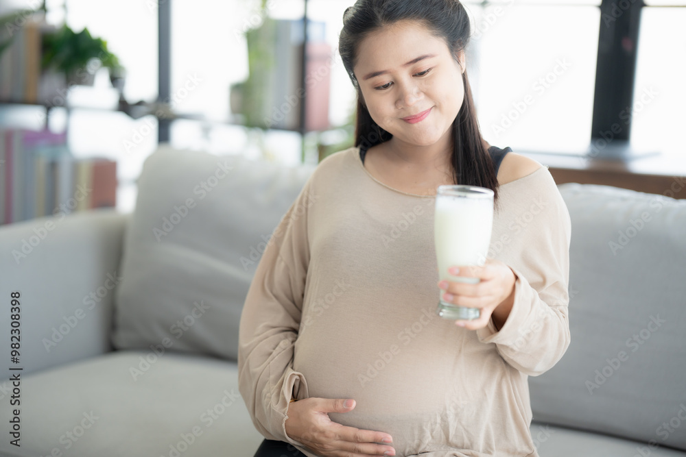 Pregnant asian woman drinking milk at home relaxation and Self-care Pregnancy drinking a glass of fresh milk mother mindfulness Positive life moment in pregnancy time Pregnant asian woman drinking milk at home relaxation and Self-care Pregnancy drinking a glass of fresh milk mother mindfulness Positive life moment in pregnancy time