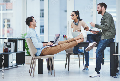 Business people, meeting and collaboration in web design, brainstorming or strategy at office. Feet up, creative men and talking to designers for teamwork, planning or online startup with laptop