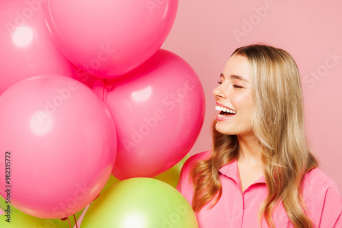 Wallpaper Mural Close up young smiling happy woman wears shirt celebrating birthday holiday and hold look at bunch of colorful air balloons isolated on plain pastel pink background studio portrait. Lifestyle concept. Torontodigital.ca