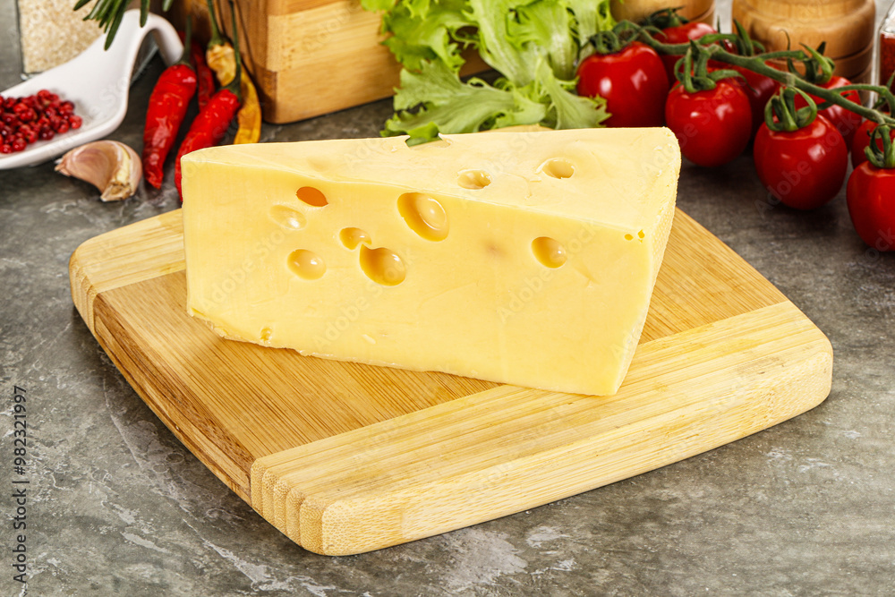 Swiss Maasdam cheese triangle over board Swiss Maasdam cheese triangle over board