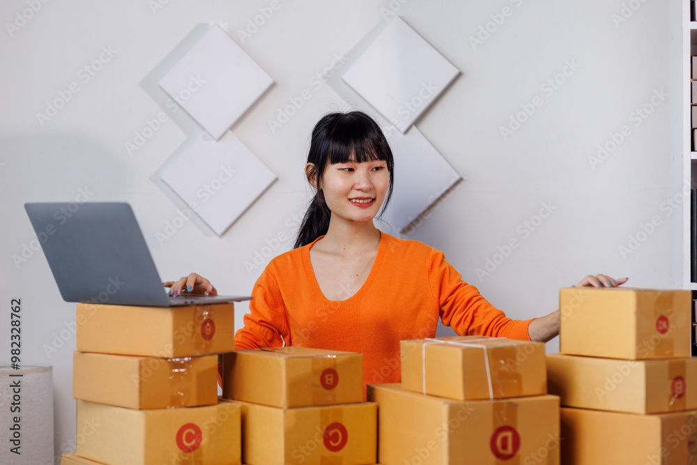 Successful woman start up online seller at workplace. small business entrepreneur SME or freelance asian woman working with box at home.
Successful woman start up online seller at workplace. small business entrepreneur SME or freelance asian woman working with box at home.