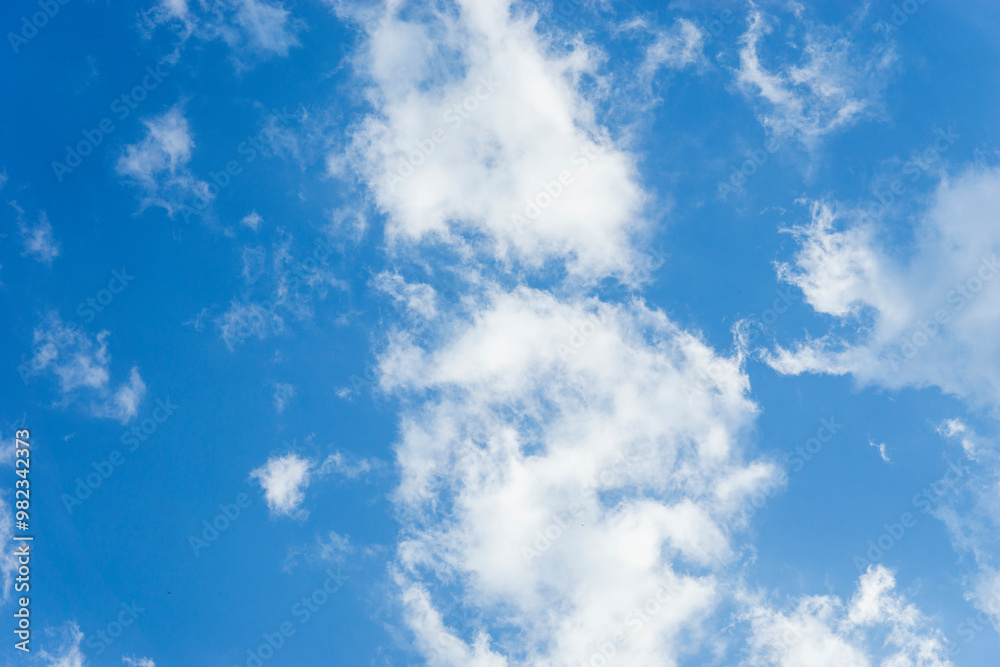 Sky is blue and clear with clouds. The sky is very bright and the sun is shining Sky is blue and clear with clouds. The sky is very bright and the sun is shining
