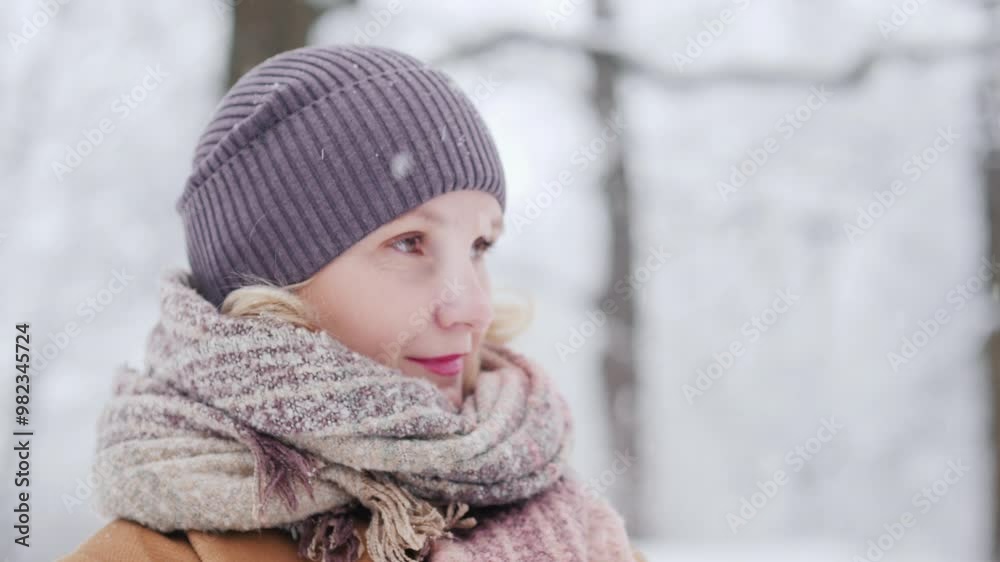 Side view of a middle-aged woman in a winter park