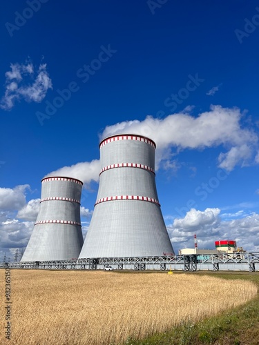 cooling towers of a nuclear power plant on a sunny day against a blue sky