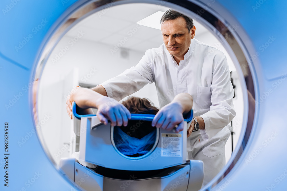 In a bright diagnostic center, a young man undergoes a CT or MRI scan using modern equipment. This image reflects the forefront of medical technology, emphasizing precision and patient care. In a bright diagnostic center, a young man undergoes a CT or MRI scan using modern equipment. This image reflects the forefront of medical technology, emphasizing precision and patient care.