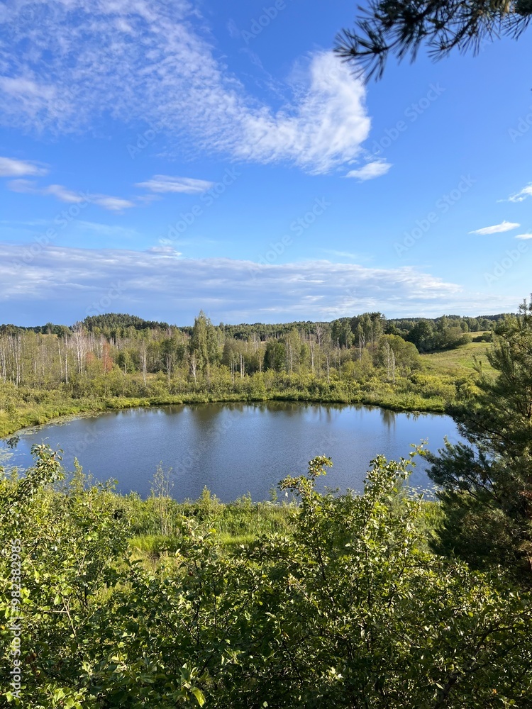 view of blue lakes on raised bog with small swamp pines blue dramatic sky summer atmosphere of wild nature reserve view of blue lakes on raised bog with small swamp pines blue dramatic sky summer atmosphere of wild nature reserve