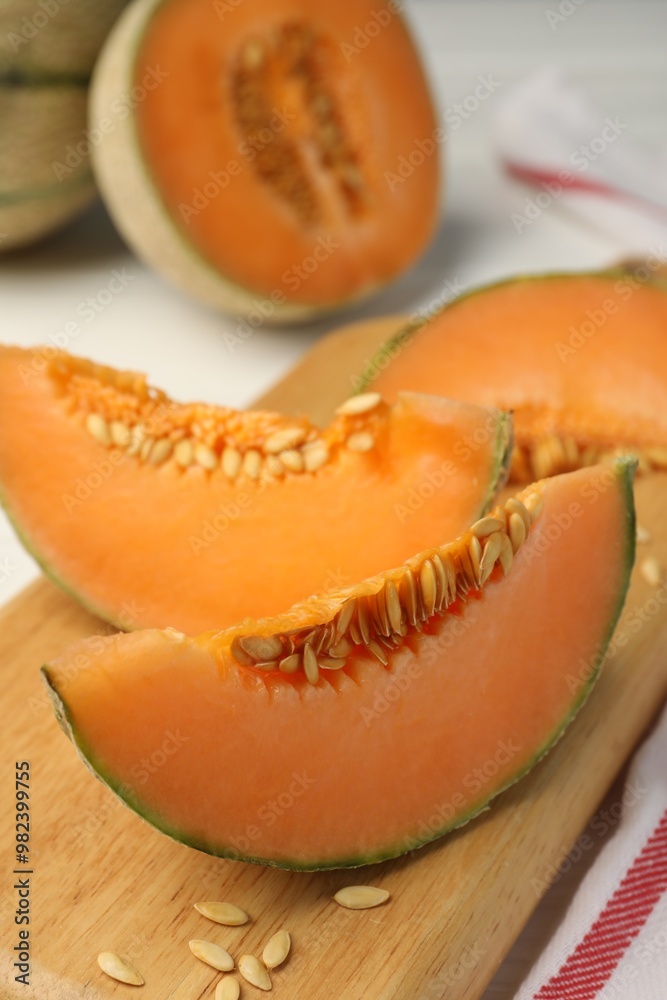 Cut ripe Cantaloupe melon on white table, closeup Cut ripe Cantaloupe melon on white table, closeup