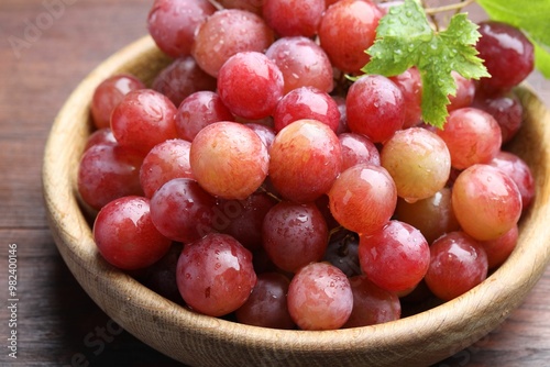 Fresh ripe grapes on wooden table, closeup