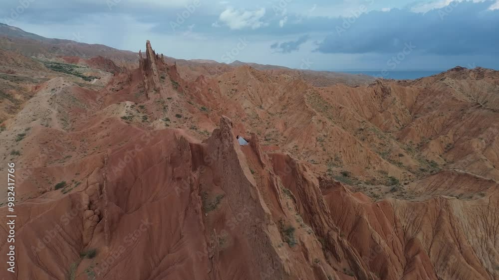 Slow orbiting shot of a hiker camping at Fairy Tale Canyon in Kyrgyzstan Slow orbiting shot of a hiker camping at Fairy Tale Canyon in Kyrgyzstan