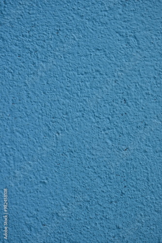 chipped old blue paint on the corner of the house, deterioration, old surface of the house 