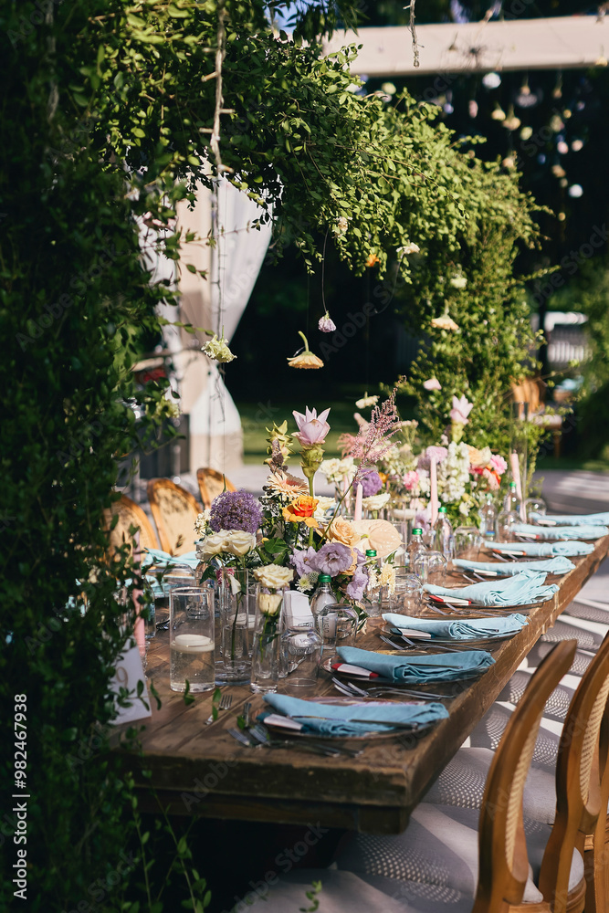 Outdoor Wedding Reception with Brown Chairs and Decorated Tables on a Green Lawn in a Scenic Nature Setting