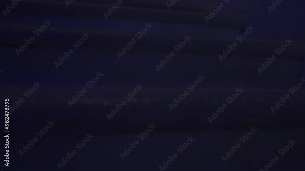 Creepy ghost woman in white dress and scary makeup alone on staircase in dark haunted house looks at camera, close up. Halloween horror concept. Creepy ghost woman in white dress and scary makeup alone on staircase in dark haunted house looks at camera, close up. Halloween horror concept.