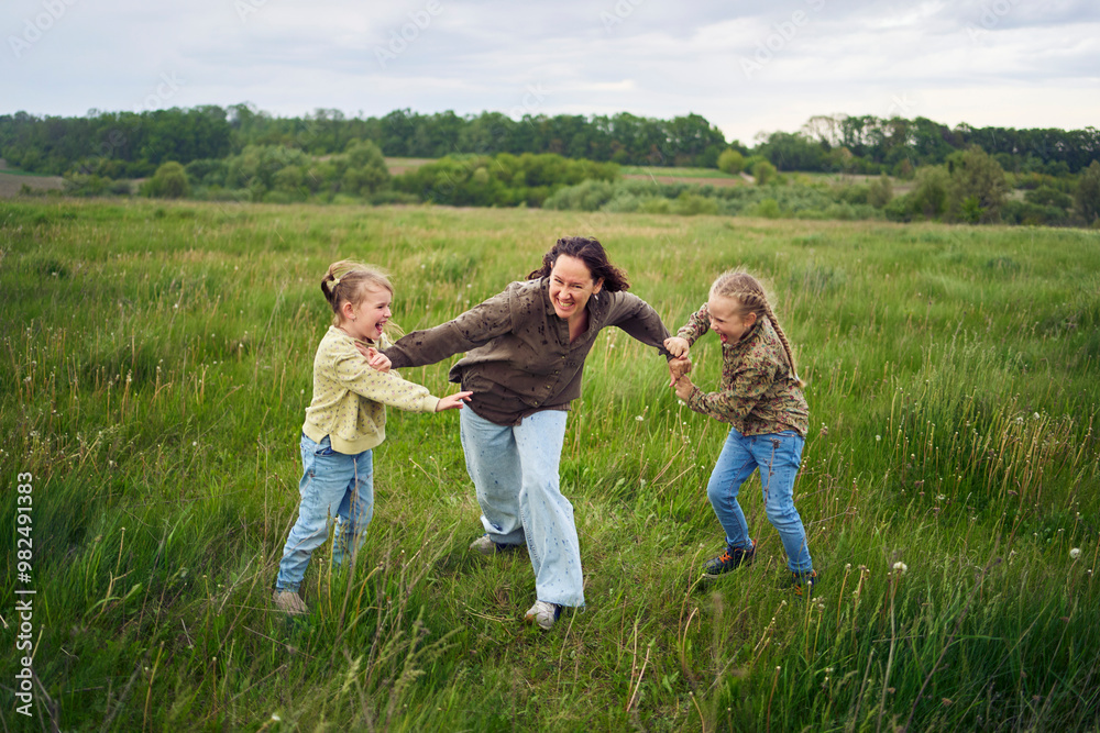 mother breaks up the children who are fighting in the rain in the field mother breaks up the children who are fighting in the rain in the field
