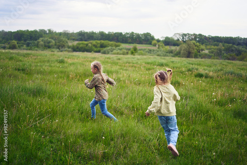 girls play catch up in a field